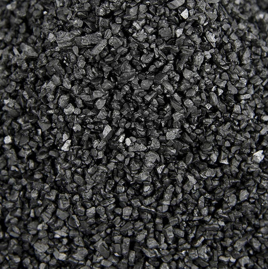 Close-up of Palm Island black Pacific salt with activated charcoal, coarse texture, 1 kg bag, ideal for decorative use, Hawaii-inspired packaging 