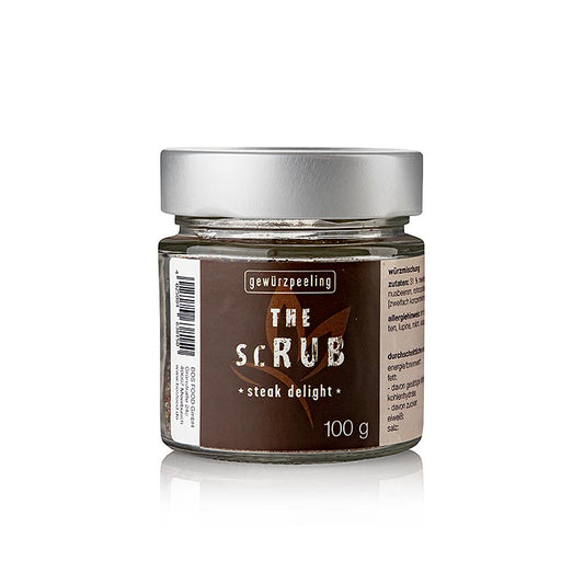  A woman's hand holding Serious Taste de scrub - steak delight 100 g product, showcasing the rich texture and premium quality