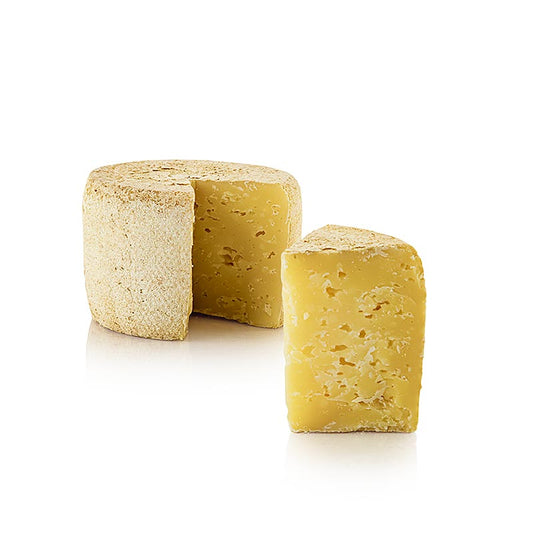 Fromage à pâte dure Deichkäse GOLD biologique de 500 g présenté sur un pain entier de Hof Backensholz